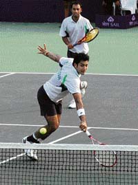 Pakistan�s Aisam-ul-Haq Qureshi plays a shot as his partner Aqeel Khan looks on during the doubles match against India�s Rohan Bopanna and Mustafa Ghouse