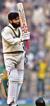 Pakistan�s Mohammad Yousuf raises his bat on completing his century during the second day of the first Test against the West Indies in Lahore on Sunday