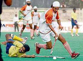 Ravi Pal of BPCL tries to stop Sukhjinder Singh of Namdhari XI during a league match of the 23rd Surjit Hockey Tournament at the Olympian Surjit Hockey Stadium in Jalandhar on Sunday