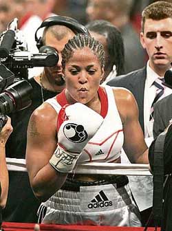 Boxer Laila Ali blows a kiss to her father Muhammad Ali after winning the WBC women�s super middleweight title bout against Shelley Burton at the Madison Square Garden in New York on Saturday