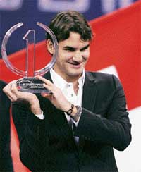 Switzerland�s Roger Federer holds the Indesit ATP trophy at an awards ceremony in Shanghai on Monday. Federer won the trophy for the third successive year after finishing the season as the world number one.