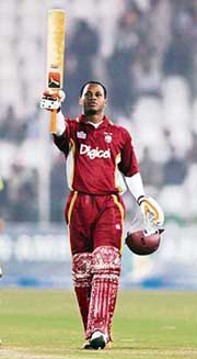 Marlon Samuels of the West Indies waves his bat after scoring a century against Pakistan during the fourth one-day in Multan on Wednesday. 