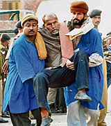 An ailing Indian national being helped to cross the Indo-Pak land border at Wagah on Saturday.
