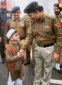 Ibrahim, son of Pakistani Ranger Col Tariq Janjua shakes hands with BSF Commandant Pradeep Katiyal on Id at Wagah border in Amritsar on Monday.