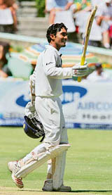 Dinesh Kaarthick celebrates his half century during the first day of the third Test against South Africa in Cape Town on Tuesday. � AFP photo