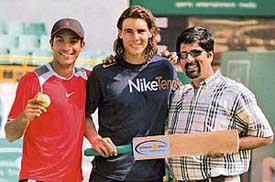 Bitten by the cricket bug, Spanish tennis star Rafael Nadal  poses with Indian tennis player Karan Rastogi and former cricketer K. Srikkanth