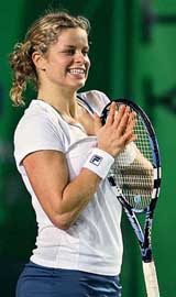 Kim Clijsters of Belgium smiles after winning a point in the singles quarterfinals against Zheng Jie of China in the Watsons Water Champions Challenge in Hong Kong on Wednesday