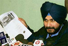 Navjot Singh Sidhu showing documents while alleging that the Punjab Government had caused a loss to the state exchequer in Chandigarh on Thursday.
