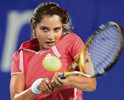 Sania Mirza plays a return to Anabel Medina Garrigues of Spain during their singles match at the Hopman Cup in Perth on Thursday. Garrigues won 3-6, 6-1, 6-3. � AFP photo