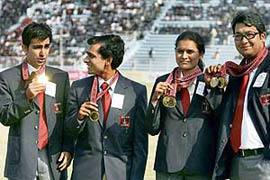 ONGC employees and Doha Asian Games gold medallists (from left) Pankaj Advani, K. Sasikiran, Koneru Humpy and Jaspal Rana pose with their medals during the inauguration of the 11th National Football League at the Ambedkar Stadium in New Delhi on Friday. 
