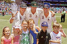 Retiring Australian cricketers (from left) Justin Langer, Glenn McGrath and Shane Warne, flanked by their children, hold the Ashes trophy after winning the fifth Test against England at the Sydney Cricket Ground on Friday