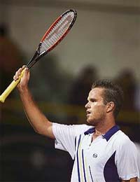 Xavier Malisse of Belgium waves to the crowd after beating Rafael Nadal of Spain in the semifinal of the Chennai Open