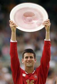 Serbia�s Novak Djokovic holds the trophy after beating Australia�s Chris Guccione in the final of the Adelaide International tennis tournament on Sunday. 