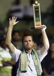Belgium�s Xavier Malisse raises the trophy after beating Austria�s Stefan Koubek in the final of the Chennai Open tennis tournament on Sunday. Malisse won 6-1, 6-3