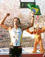 Brazil�s Adriano Bastos celebrates with cartoon character Pluto after winning the Walt Disney World Marathon in Lake Buena Vista, Florida,