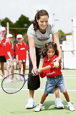 Serbian player Ana Ivanovic trains a girl during a clinic for kids on the sidelines of the Sydney International tennis tournament