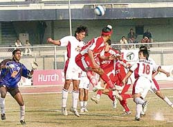 JCT�s Baldeep Singh (centre) attempts a header as Mohun Bagan�s Dharamjit Singh (No. 18) looks on in the 11th National Football League at Ludhiana�s Guru Nanak Stadium