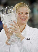 Kim Clijsters of Belgium holds the Waterford trophy after defeating Jelena Jankovic of Serbia in the final of the Sydney International tennis tournament