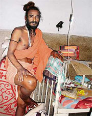 Baba Budh Giri of Dholbaha village stands on a foot despite his ailment in a hospital in Hoshiarpur.