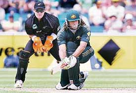 Andrew Symonds of Australia plays a sweep shot during a tri-series one-day match against New Zealand in Hobart on Saturday