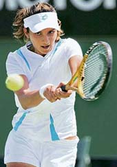 Sania Mirza hits a return against Olga Savchuk of Ukraine in their singles first round match at the Australian Open in Melbourne