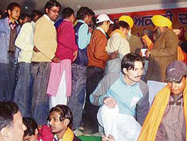 Youth queue up to receive siropas at a political function in Mandi Ahmedgarh on Thursday.