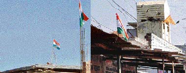 Flags of political parties flutter atop roofs in the Kanuwan constituency