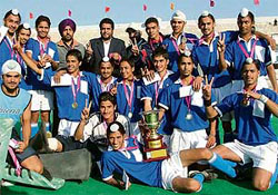 Players of Government Model School, Jalandhar, pose with the trophy after winning the 3rd All-India S. Balwant Singh Kapur Memorial Hockey Tournament in Jalandhar