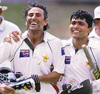Pakistan�s Younis Khan and Kamran Akmal return to the pavilion after guiding Pakistan to victory in the second Test against South Africa in Port Elizabeth on Monday. 