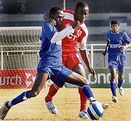 Dempo stopper-back Bolaji Majeck (left) tries to keep the ball in control as JCT striker Edeh Chidi tries to dispossess him in a National Football League match at Ludhiana�s Guru Nanak Stadium on Monday. 