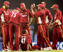 Caribbean players celebrate after restricting India to 268 during the third one-dayer at the MA Chidambaram Stadium in Chennai on Saturday. Dwayne Bravo (sitting) was the wrecker-in-chief with a haul of 4-39 as the West Indies won by three wickets. � PTI photo
