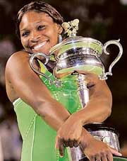 Serena Williams of the USA clutches the trophy after beating Russia�s Maria Sharapova in the women�s singles final at the Australian Open in Melbourne on Saturday. Serena won 6-1, 6-2.