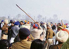 Policemen resort to a lathi charge to disperse the agitating SAD workers on the Beas-Jalandhar highway