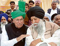 Mr Om Prakash Chautala and the SAD-BJP candidate from Banur, Capt Kanwaljit Singh, discuss a point during a rally in Mukandpur village