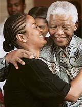 Laila Ali, daughter of boxing legend Mohammed Ali, gives a hug to former South African President and Nobel Peace prize laureate Nelson Mandela
