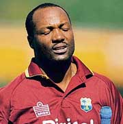 A despondent Brian Lara walks back to the pavillion after being dismissed