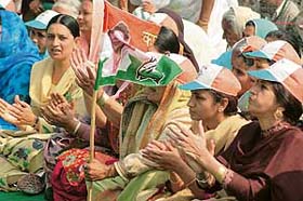 Women activists of the Congress attend an election meeting of party candidate Amrik Singh Dhillon in Samrala