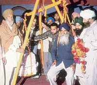 A candidate of the SAD (1920) is weighed against ladoos at Daomajra village near Kharar