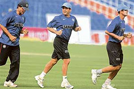 Sourav Ganguly, Sachin Tendulkar and Rahul Dravid jog during a practice session in Kolkata