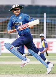 Virender Sehwag runs beween the wickets during a training session at the Madhavrao Scindia Stadium in Rajkot 