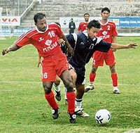 Players of Punjab (left) and Haryana fight for the ball during a group match at the 33rd National Games in Guwahati 