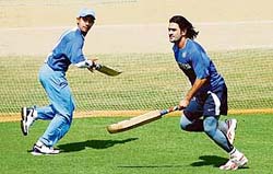 Dinesh Karthik (left) and Mahendra Singh Dhoni run between wickets during a training session in Margao