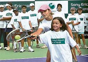 Tennis star Sania Mirza gives tips to a kid during a camp in Bangalore