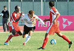 East Bengal skipper Alvito D� Cunha (centre) tries to get past JCT�s Adebayo Tokunbo (left) in the 11th National Football League at Ludhiana�s Guru Nanak Stadium 