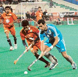 Albert (right) of Chennai Veerans being checked by Arjun Hallapa of Bangalore Lions during their Premier Hockey League match at the Sector 42 Hockey Stadium in Chandigarh