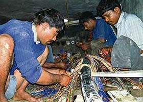 BSNL staff lay a new underground cable to restore telecom services in Pathankot city