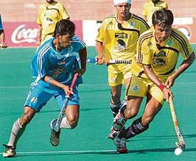 Sher-e-Jalandhar�s Gagan Ajit Singh (right) gets past a Chennai Veerans� player during the PHL match at the Sector 42 Hockey Stadium in Chandigarh on Friday. The Shers won 6-0