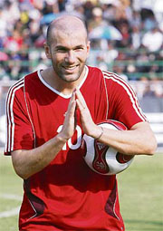 French football star Zinedine Zidane gives a traditional Thai salute to fans before a charity match at Chiang Mai City Municipality Stadium in Chiang Mai Province, north of Bangkok