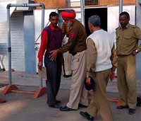 Personnel of the Punjab Police frisk people outside the counting centre, Phase VI, Mohali