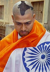 Sharun Sharma, a die-hard cricket fan, shows his �Indian map� hairstyle in Jamshedpur on Thursday. Sharun says he can go to the extent of selling one of his kidneys to go to the West Indies for the World Cup.